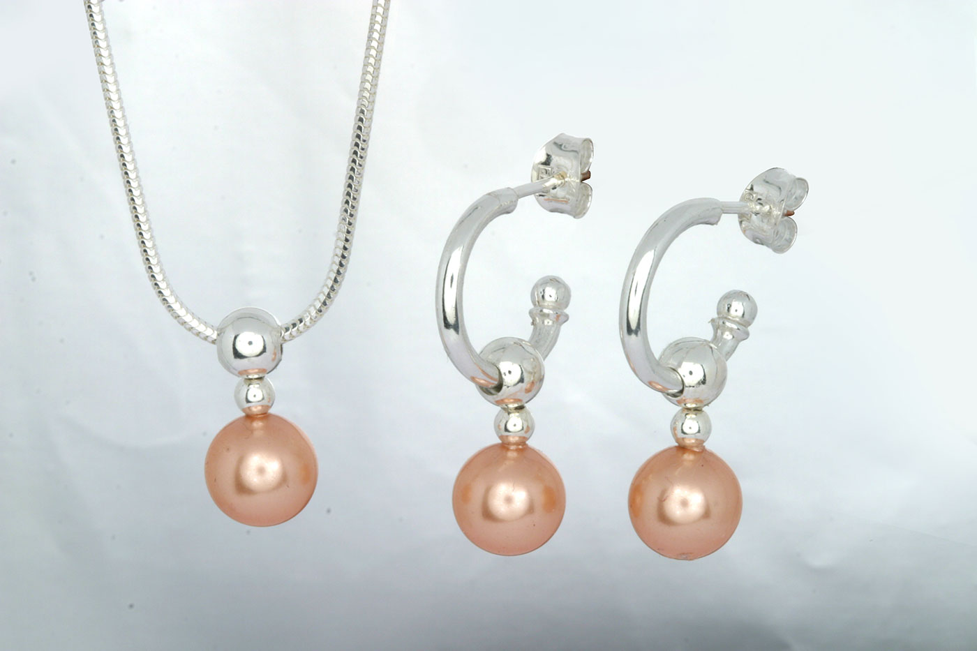 Korvakorut 3104, 3/4 rengas 14/2mm, tappi 0.9/10mm. Hinta: 26€<br/>
							Riipus 5104, 16mm. Hinta: 16€<br/>
							Swarovski lasihelmet Ø 8mm, väri: rosa beach. 925 hopeaa<br/>
							Hopeinen käärmeketju 1.2mm, 45cm. Hinta: 14€